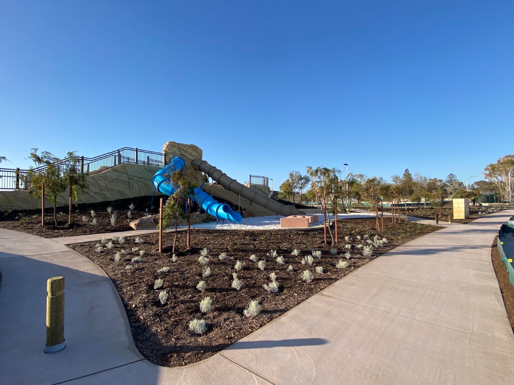 A playground at Capricorn Beach with a slide and a water feature, providing fun and entertainment for children.