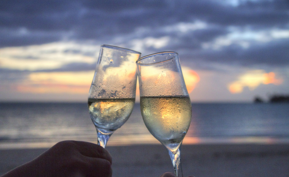 Date Ideas in Yanchep Champagne glasses clinking at sunset, perfect for date ideas in Yanchep