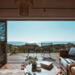 Stunning beachside living room with an open view of the ocean, featuring modern furniture and a cosy interior