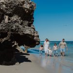 A family enjoying a sunny day at the beach, highlighting the opportunity to live by the beach