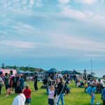 Yanchep Pop-Up with market stalls and people enjoying coastal summer activities by the sea