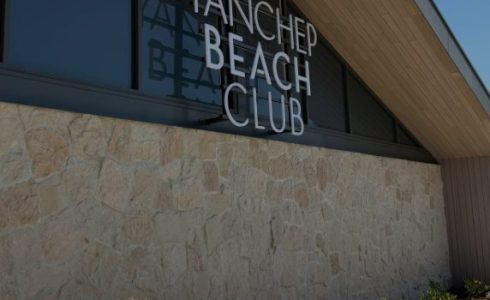 Exterior signage of the Yanchep Beach Club overlooking the coastal building façade.