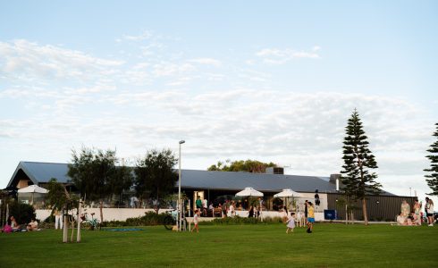 People enjoying the open community space at Yanchep Beach Club near Capricorn Beach.
