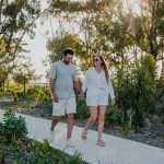 Couple walking hand in hand along a landscaped path in Yanchep, where a new local farmers market opens this spring